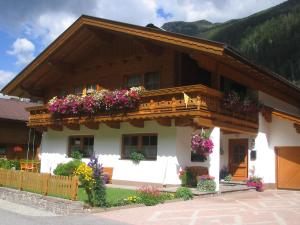 a house with flower boxes on the balcony at Ferienwohnung Maria Erlsbacher in Sankt Veit in Defereggen