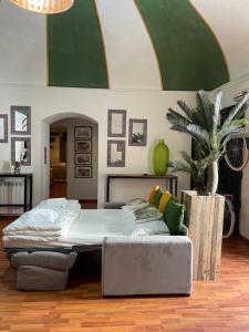 a bedroom with a bed and a couch in it at Bibike in Catania