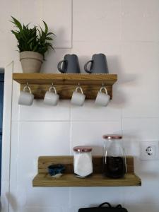 a shelf with cups and pots on a wall at MIRAMELINDO Encantador apartamento con terraza panorámica in Mojácar