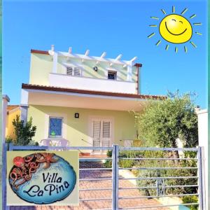 a house with a sign in front of it at villa "LA PINA" in Valledoria