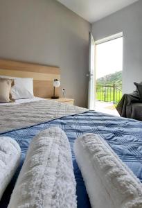a bedroom with a large bed with a large window at Stelios Studios Sougia in Sougia