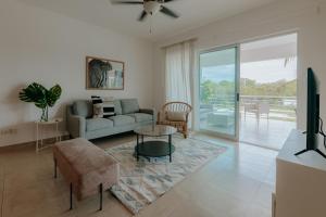 a living room with a couch and a table at Lumina at Jardines Punta Cana Village in Punta Cana
