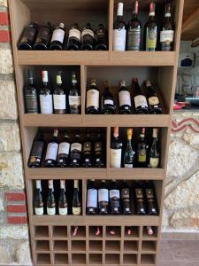 a cabinet filled with lots of bottles of wine at Hotel Natali in Dhërmi