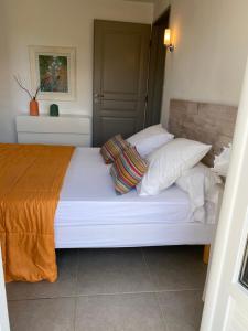 a bedroom with a white bed with pillows at Valle Di Casa in Sotta