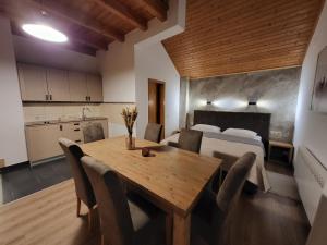 a kitchen and dining room with a table and a bed at House Tina in Grabovac