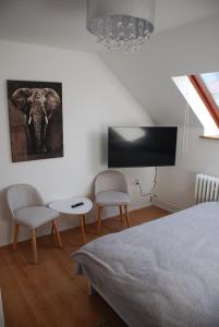 a bedroom with an elephant picture on the wall at Kúzelná Špajza in Terchová