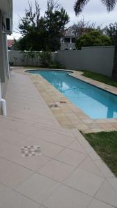 a swimming pool in front of a house at Park Place Boutique Guesthouse in East London