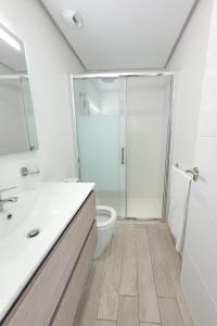 A bathroom at Ocean Garden Sunset Apartment - heated swimming pool Free WIFI