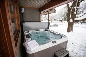 a jacuzzi tub in an rv in the snow at Mackenzie House by Revelstoke Vacations in Revelstoke