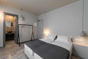 a bedroom with a large bed and a mirror at Ios Fantasy in Ios Chora