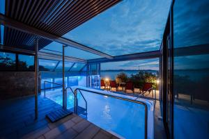 a house with a swimming pool at night at Vila LEDA in Kožino