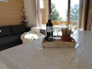 a bottle of wine and two glasses on a table at Appartement 2 Chambres au calme in Les Angles +6 photos