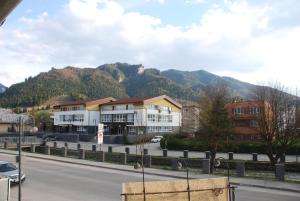 a street in a town with mountains in the background at Kúzelná Špajza in Terchová