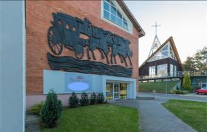 a building with a mural on the side of it at Studio & Sunrise Nida in Nida