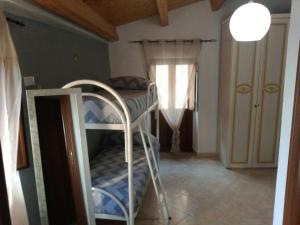 a bedroom with a bunk bed and a window at A Taverna Intru U Vicu in Belmonte Calabro