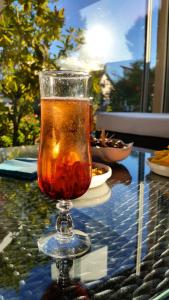 a drink in a glass on a table at Hôtel Villa Teranga in Andernos-les-Bains