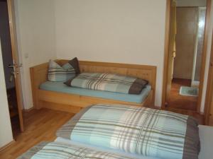 a bedroom with a bed with a wooden frame and a mirror at Haus Fliri in Curon Venosta +31 photos