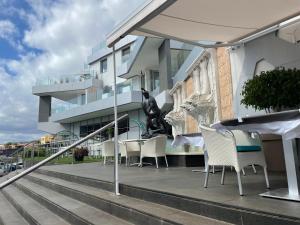 A balcony or terrace at Ocean Garden Sunset Apartment - heated swimming pool Free WIFI