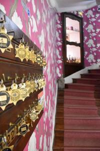 a room with a staircase with clocks on the wall at Hôtel La Villa Lorraine in Toul