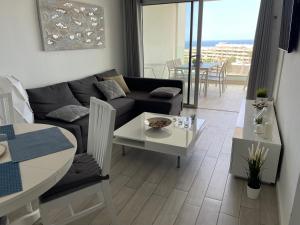 A seating area at Ocean Garden Sunset Apartment - heated swimming pool Free WIFI