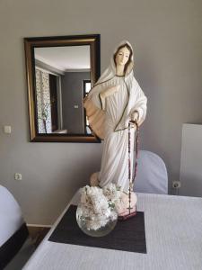 a statue of a woman in a robe on a table at Rooms Nikola Rule Ostojic in Međugorje