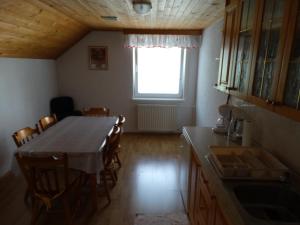 a kitchen with a table and chairs and a window at Rooms-Apartment Renata in Bled +17 photos