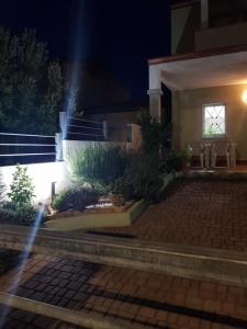 a house at night with a beam of light at villa "LA PINA" in Valledoria +17 photos