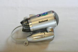 a metal hair dryer sitting on top of a table at Star Hotel Koriyama in Koriyama
