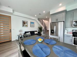 a kitchen and dining room with a table and chairs at Hollywood Art Gallery House - Iconic LA Views in Los Angeles