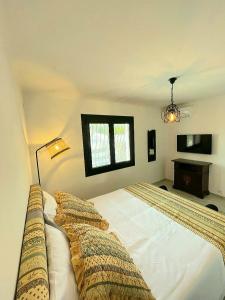 a bedroom with a large white bed and a desk at Villa Cocody in Bandol