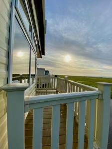 a balcony of a house with a view of the ocean at Ocean Edge Holiday Park Family holiday home with spectacular sea views in Heysham