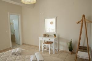 a white room with a table and a mirror at Maresia Apts & Studios in Arillas +80 photos