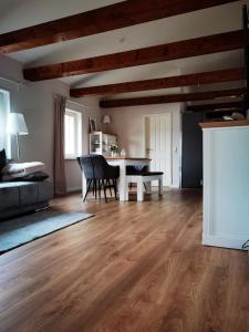 a living room with wooden floors and a table at Ferienwohnung City Loft in Kiel