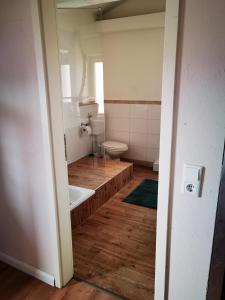a small bathroom with a toilet and a sink at Ferienwohnung City Loft in Kiel