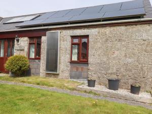 a house with solar panels on the side of it at Kestrel Corner in Lanivet