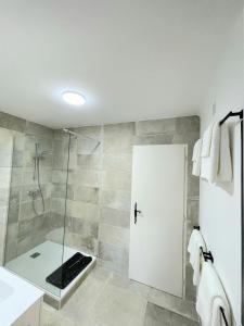 a bathroom with a shower with a glass door at Villa Cocody in Bandol