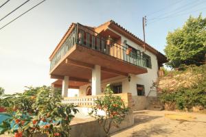 a house with a balcony on top of it at Country house Godall in La Galera