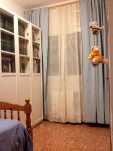 a bedroom with a window with blue curtains at Country house Godall in La Galera +19 photos