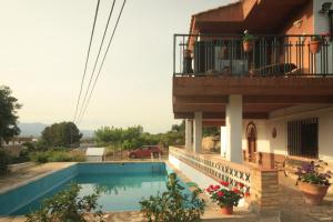 a house with a swimming pool and a balcony at Country house Godall in La Galera
