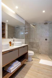 a bathroom with a sink and a toilet and a shower at Villaz Luxury Vacation Homes in Medellín