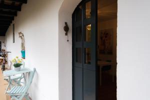 a door to a house with a chair and a table at Vista Corral del Conde in Seville