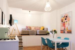 a living room with a table and chairs and a couch at Vista Corral del Conde in Seville
