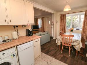 a kitchen and living room with a table and a dining room at Westgate Cottage in Pickering +10 photos