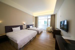 Postel nebo postele na pokoji v ubytování Sunseed International Villa Hotel