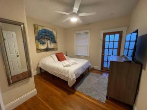 a bedroom with a bed and a ceiling fan at Cozy Large House close to TUFTS/Harvard/MIT 4BR in Medford