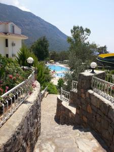a resort with a swimming pool in the background at Nicholas Park Hotel in Fethiye