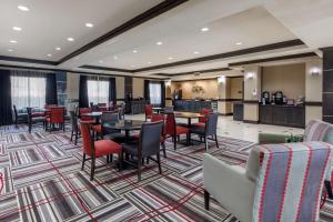 a restaurant with tables and chairs in a room at Best Western Plus DFW Airport West Euless in Euless