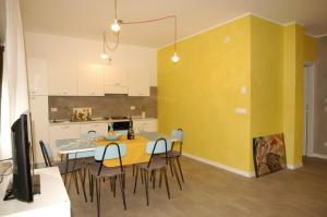 a kitchen and dining room with a table and chairs at Il girasole in Dervio