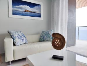 a living room with a couch and a table at SUNSET WAVES sea & sky apartment in Benidorm