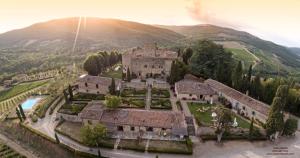 an aerial view of a castle in the mountains at Castello Di Meleto Wine Destination - Camere in Castello e Appartamenti in Gaiole in Chianti